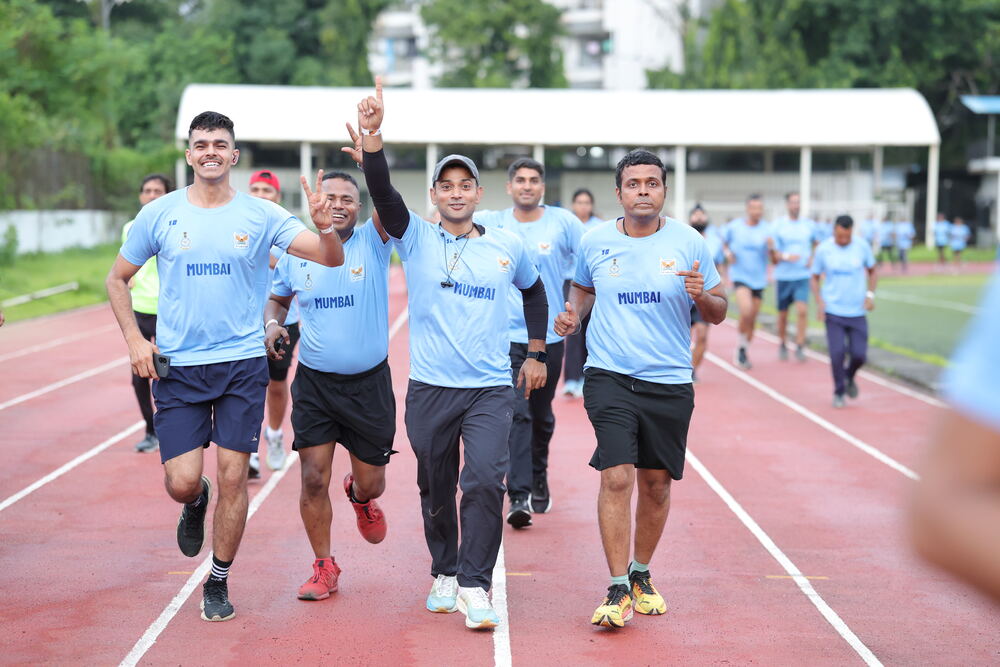 Runners celebrating on the track with victory fist