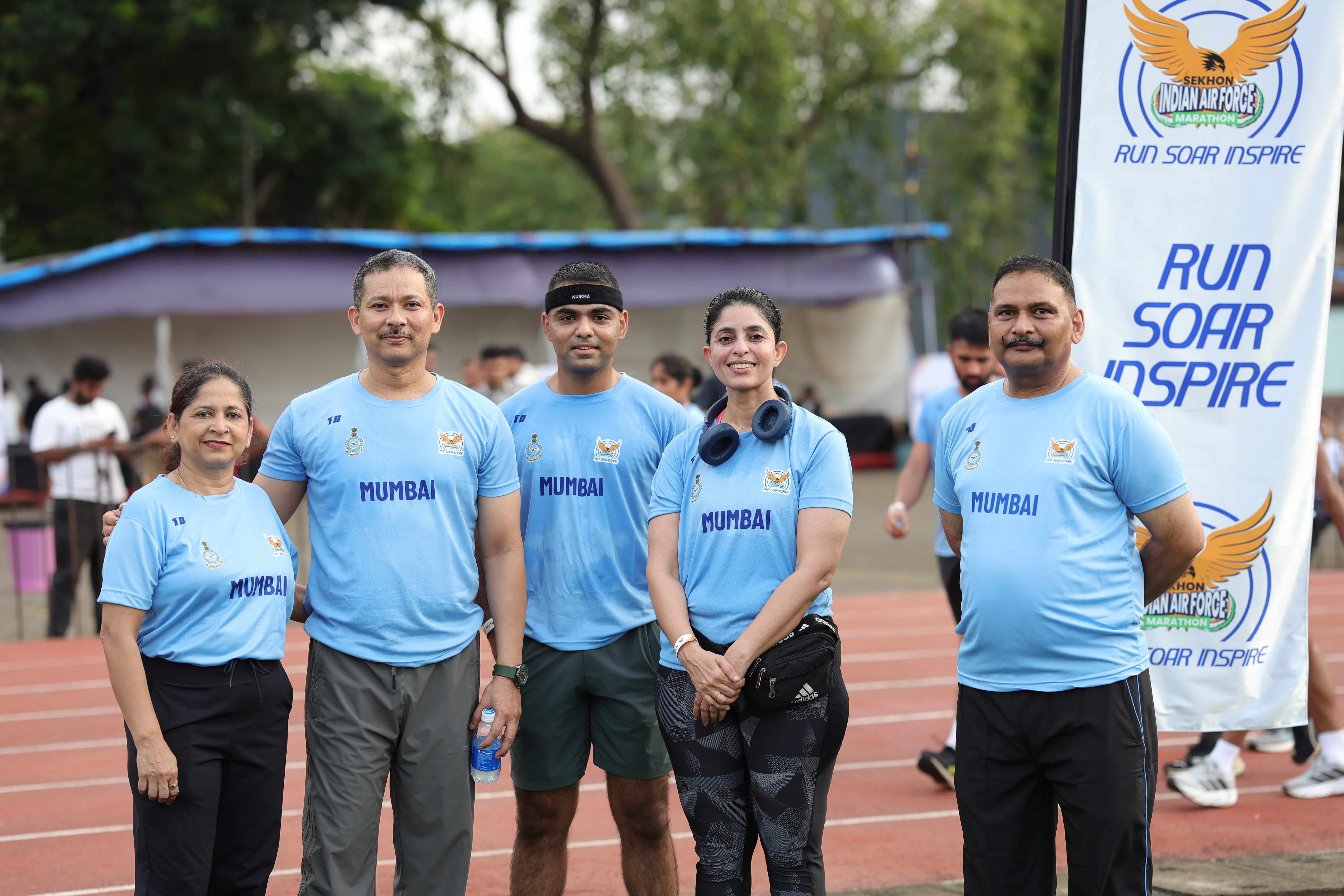 Air Force officers and runners holding the Run Soar Inspire banner