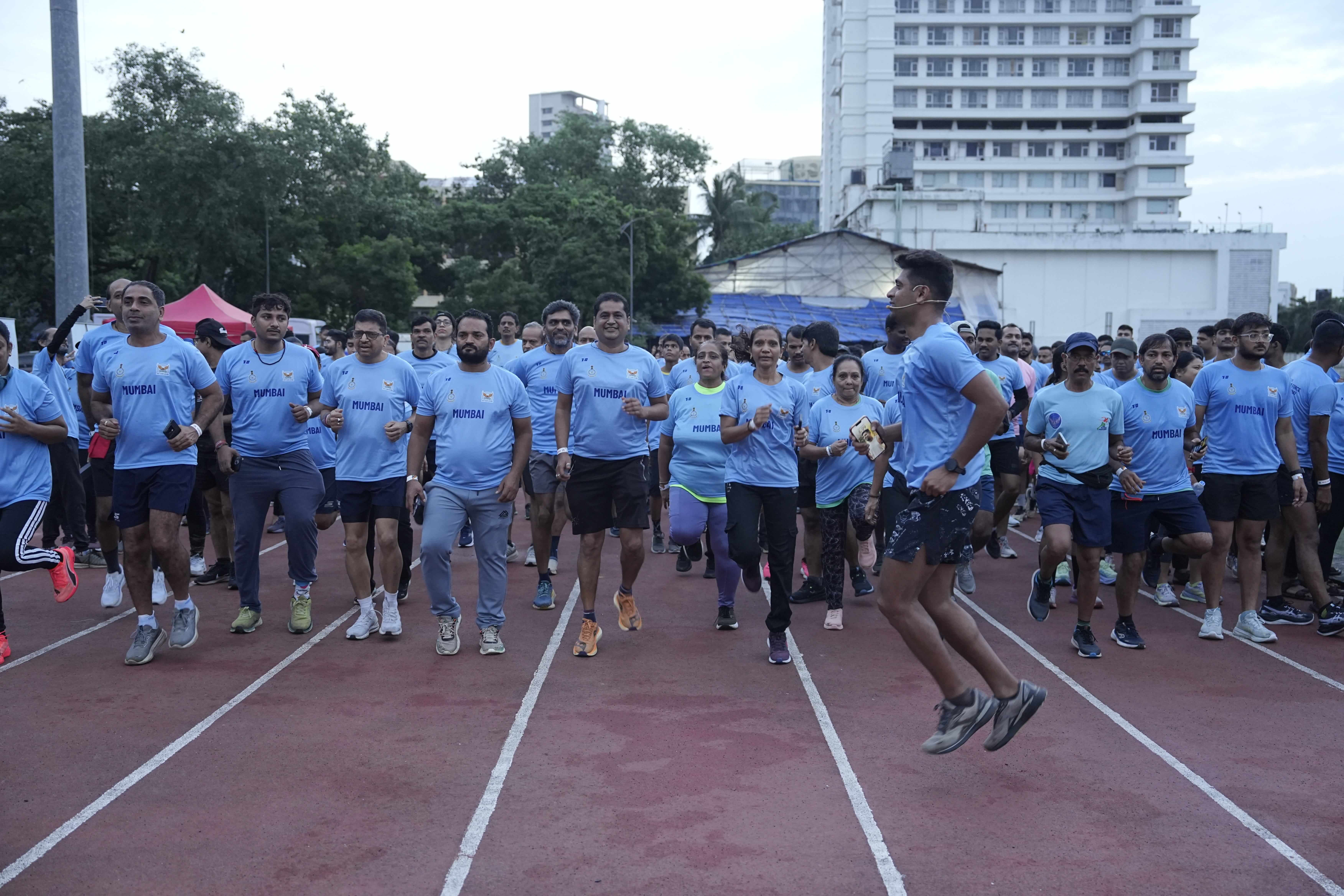 Fitness coach leading morning running drills
